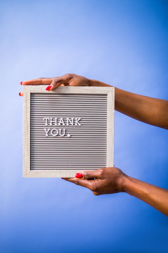 services-03 Hands holding thank you sign on blue backdrop, perfect for social media and digital marketing.